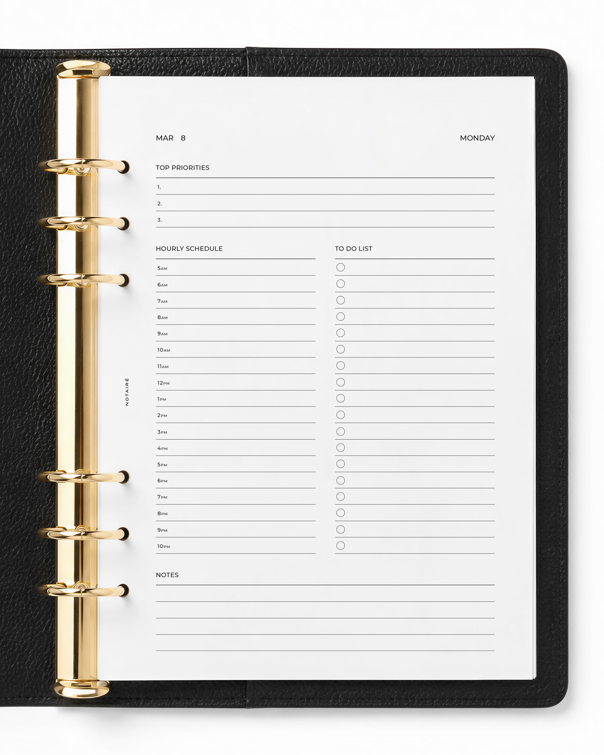 An open black leather-bound planner with gold-tone ring binder hardware, showing a white Notaire weekly schedule page with lined sections for priorities, hourly schedule, to-do list, and notes.