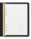 An open black leather-bound planner with gold-tone ring binder hardware and Notairé weekly planner pages, photographed from above on a white background.