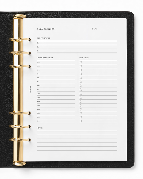 A daily planner Notairé insert page from a black leather-bound ring binder planner with gold-tone metal rings, shown on a white background.